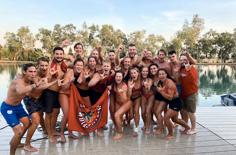 waterski team poses at lake