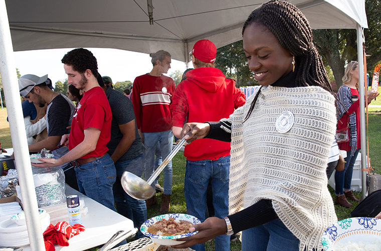 Students eating gumbo at Ragin' Cajuns tailgating tent
