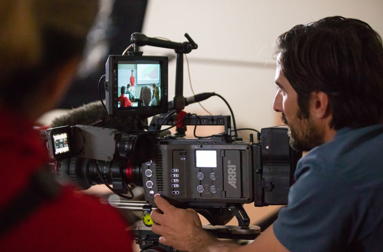 A cameraman filming in a University of Louisiana at Lafayette classroom