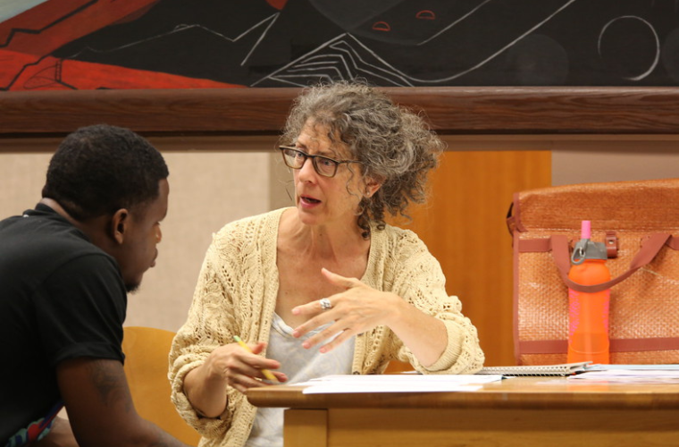 women speaking to man in academic setting 