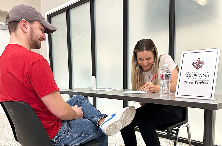 A Career Services representative helps a UL Lafayette student with their resume