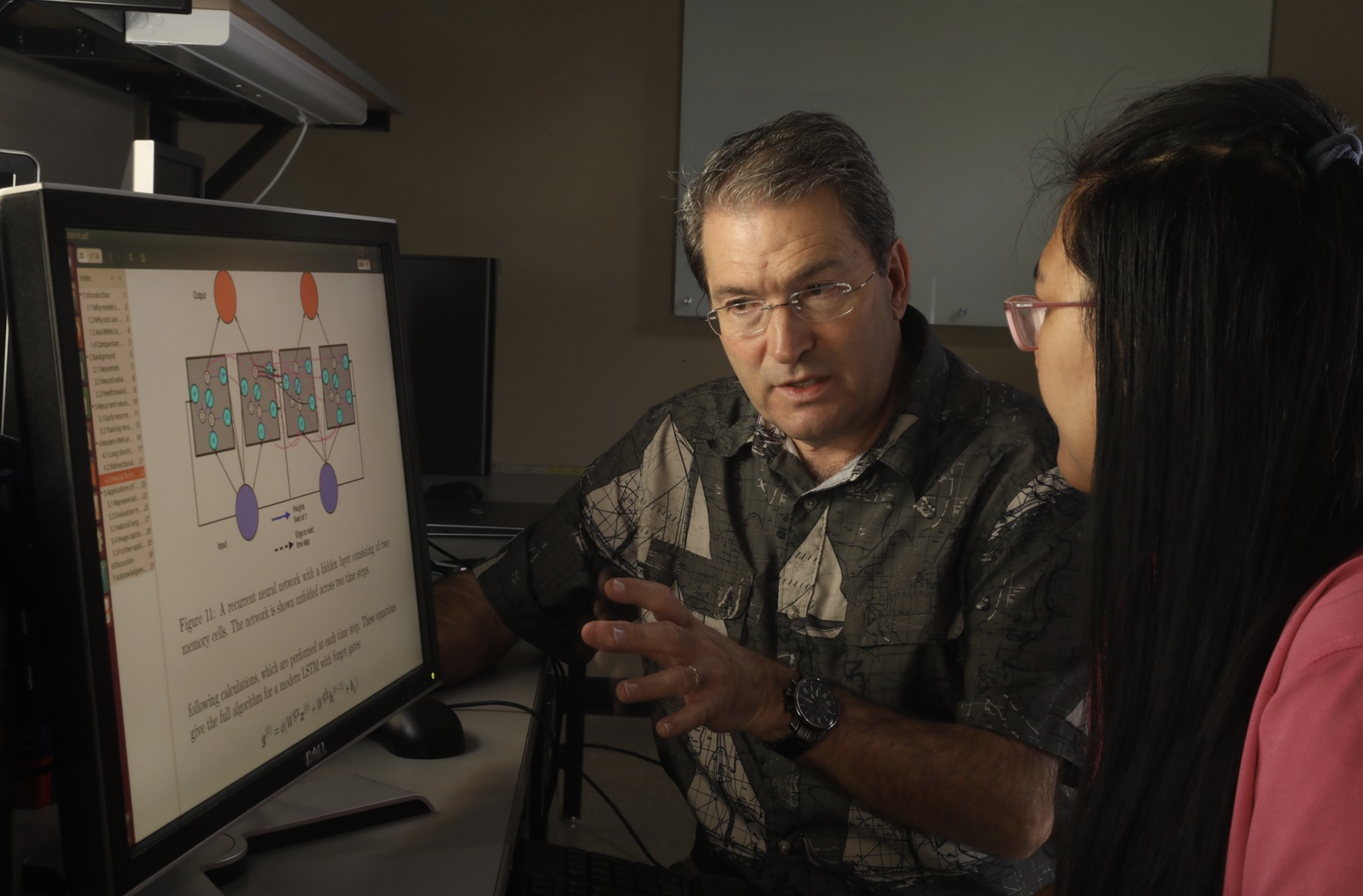 Dr. Michael Totaro guides a student at a computer. Totaro is the graduate coordinator for the MS in Informatics on campus and online.