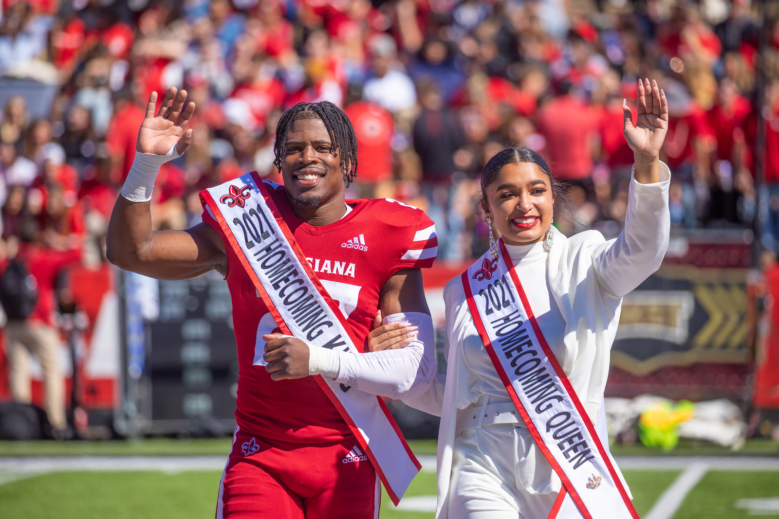 TJ Wisham is pictured in his football uniform and homecoming king sash with the 2021 homecoming queen. Wisham earned his MS in Systems Technology online from UL Lafayette.