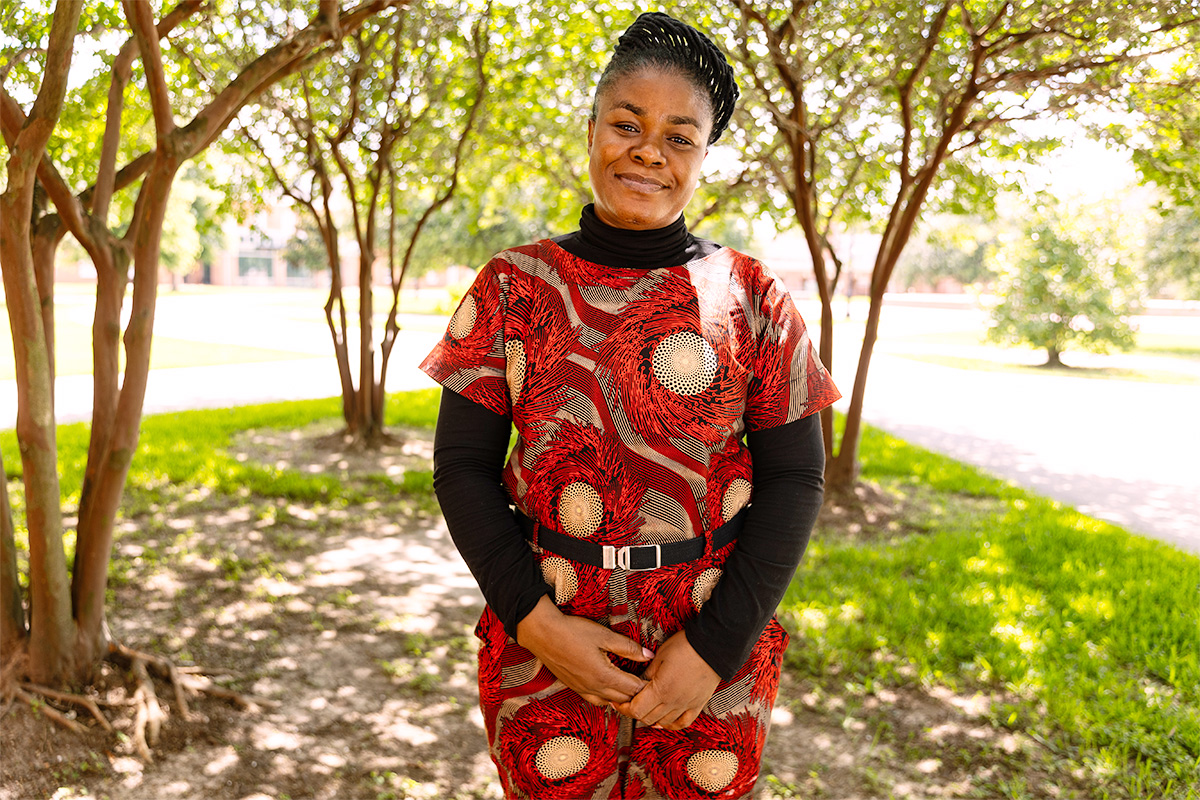 Nchedo Nwankwor on UL Lafayette's campus surrounded by trees.