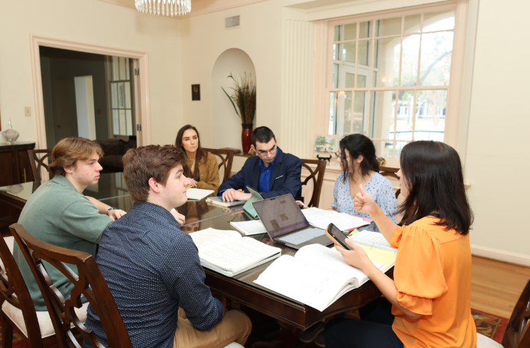 Group of music students meeting at a table.