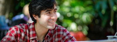 University of Louisiana at Lafayette student smiles while studying in front of his computer
