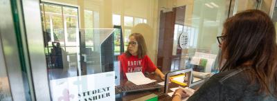 Student Chashier Center employee helping a student at UL Lafayette