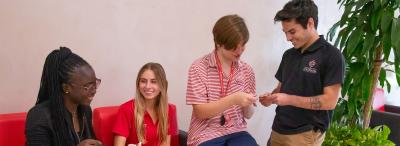 Four UL Lafayette students looking at their new cajun cards together
