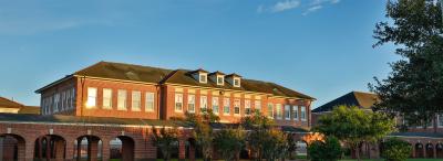 View of UL Lafayette's Lee Hall with "TUTORING" sign through windows