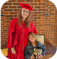Online HPW graduate smiles with daughter wearing a red UL Lafayette cap and gown. 